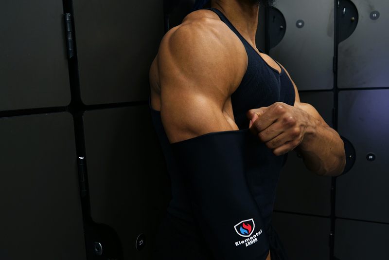 Athlete pulling on the Elemental Armor Elbow Sleeve