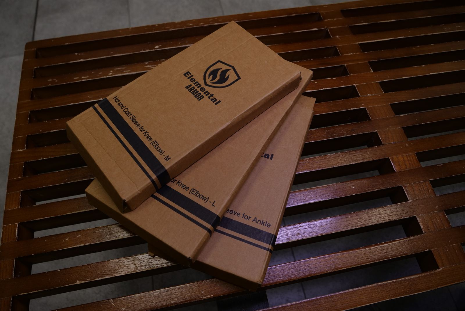 Elemental Armor shipping boxes stacked on a wooden bench