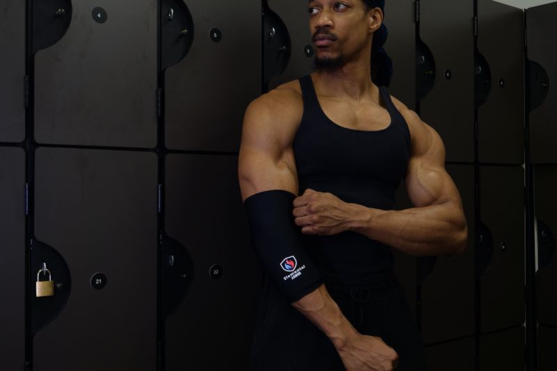 Athlete in a locker room wearing the Elbow Sleeve