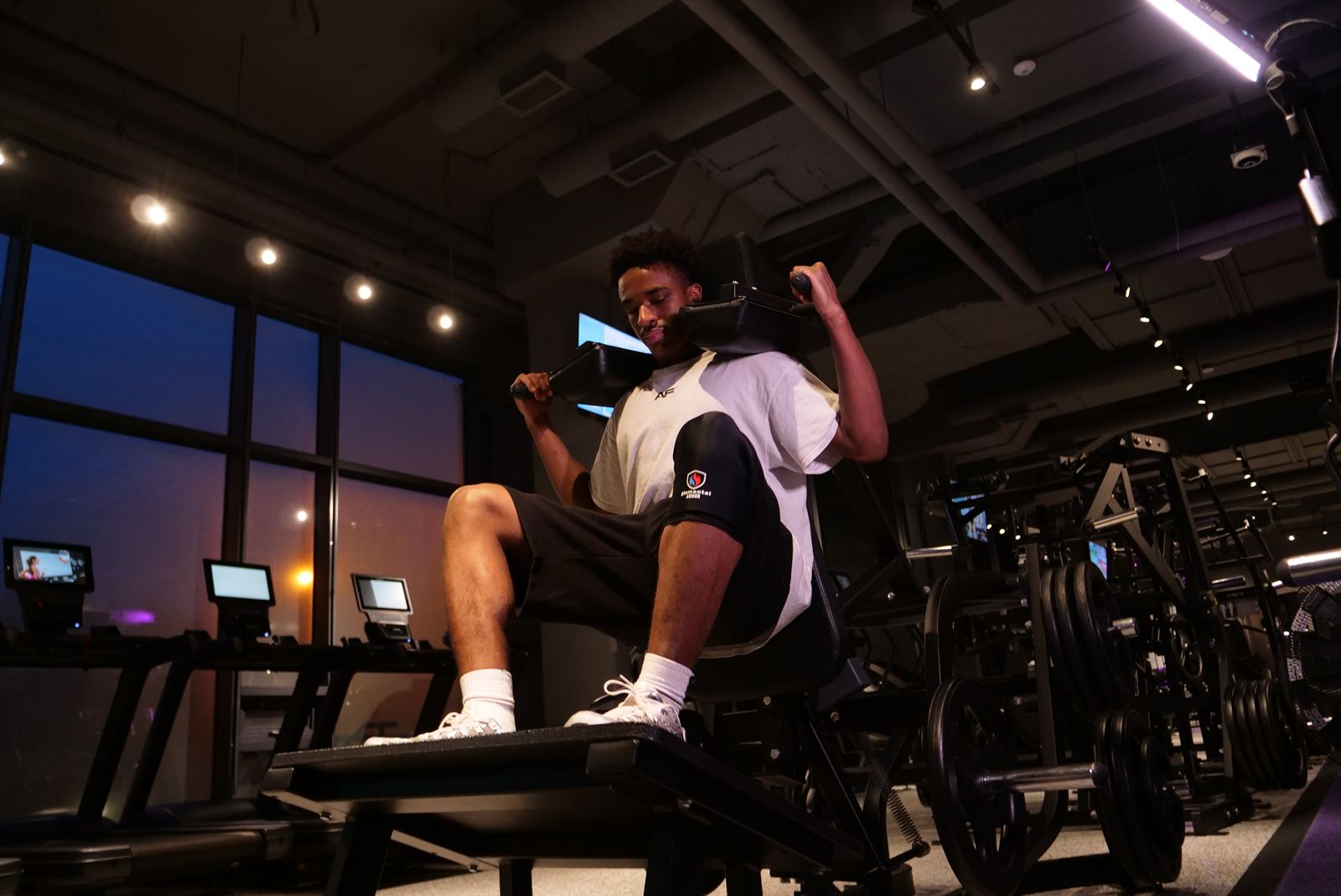 Athlete training on a gym machine wearing the Elemental Armor Knee Sleeve
