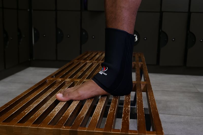 Elemental Armor Ankle Sleeve worn with the foot resting on a bench